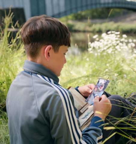 Image showing the boy looking at a photo of his grandad