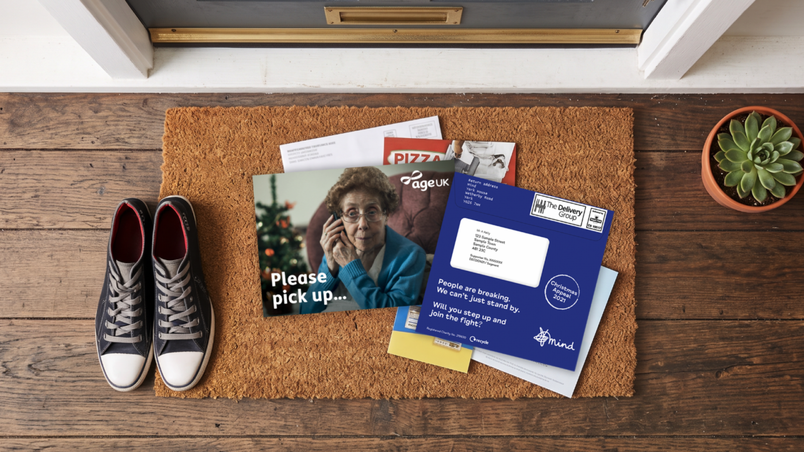 DM Outers Christmas_desktop | Consider Christmas direct mails scattered on a brown carpet, including a cover image of an elderly woman and the text 'Please pick up...'.